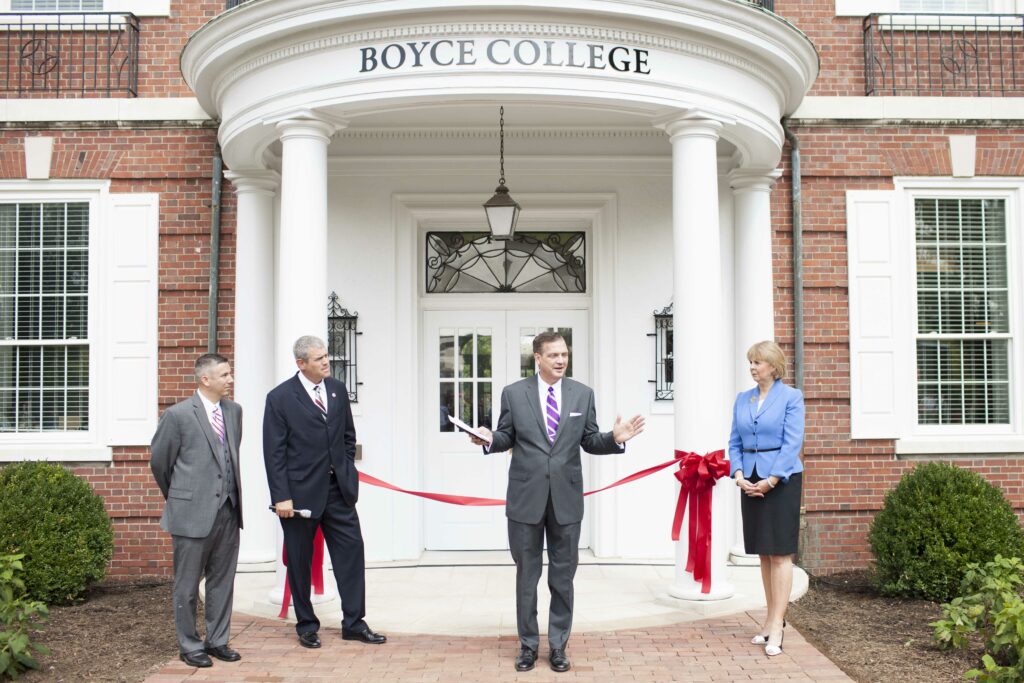 Albert Mohler, standing in front of a building (and college) named in the honor of the slave-holding founder of the SBC.