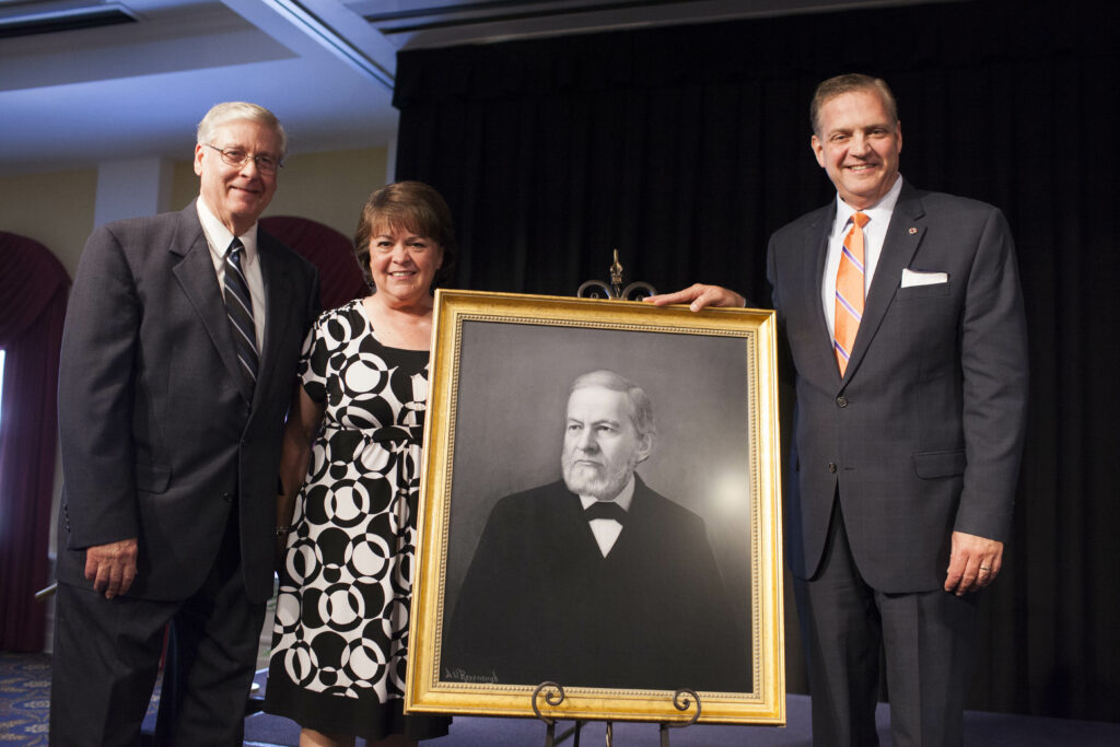 Albert Mohler, standing proudly with a photo of Confederate captain, John Broadus. 